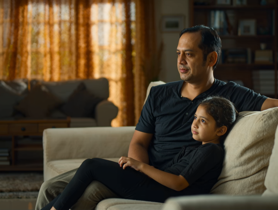 A Malaysian father and daughter in a warm family moment at home